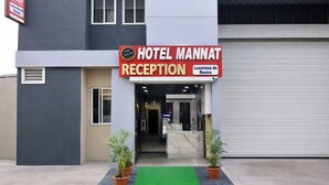 A hotel reception with a sign indicating 'HOTEL MANNAT RECEPTION' and 'Luxurious Ac Rooms'. - Fabhotel Mannat (Indore)