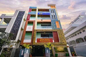 A multi-story hotel with a prominent sign for 'Hotel Anoos Minarva Kitchen' and 'fab hotels' branding. - Fabhotel Anoos (Hyderabad)