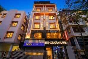A multi-story building with a sign for 'The Corporate Inn' and 'fabHOTELS' on the ground floor. - Fabhotel The Corporate Inn I (Kolkata)