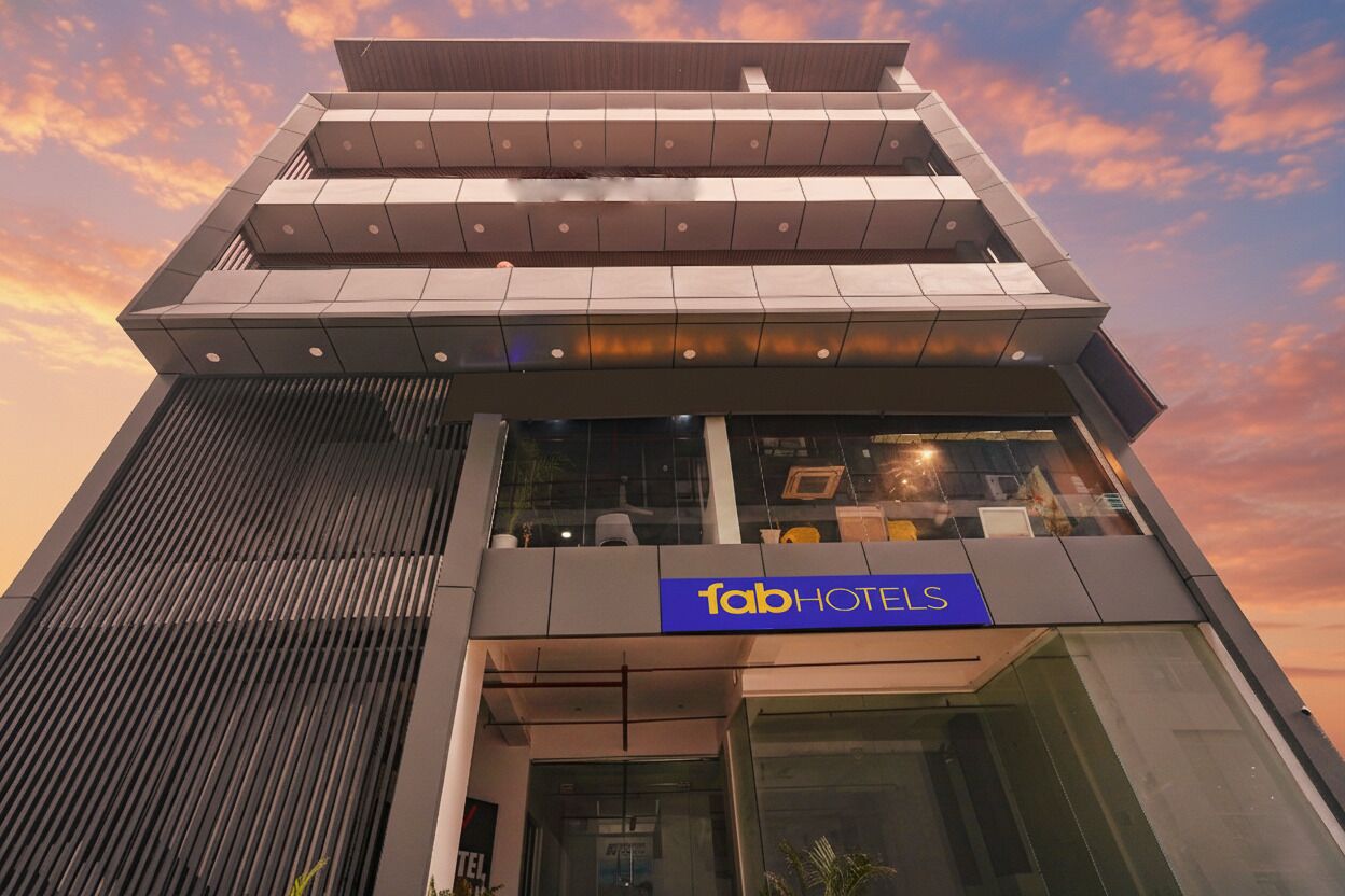 A modern hotel building with a prominent 'fabHOTELS' sign.