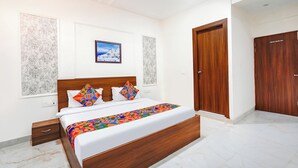 A bedroom with a wooden bed, a ceiling fan, and a door.