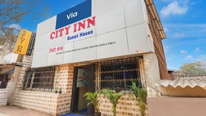 A CITY INN Guest House with a signboard, a blue sky, and a brick facade. - FabHotel AK Residency (Mumbai)