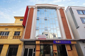 A hotel with a modern facade, large windows, and a sign indicating 'Hotel Vishesh Continental' with 'AC Rooms Available'. - Fabhotel Vishesh Continental (New Delhi)