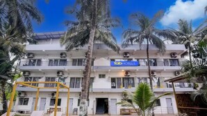 A multi-story building with a sign for 'fab hotels'. - FabHotel Bay Breeze - 800M From Morjim Beach (Morjim)