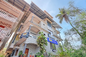 A multi-story hotel with balconies, a reception area, and signs for 'Crystal Bay Baga' and 'Fab Hotels'.