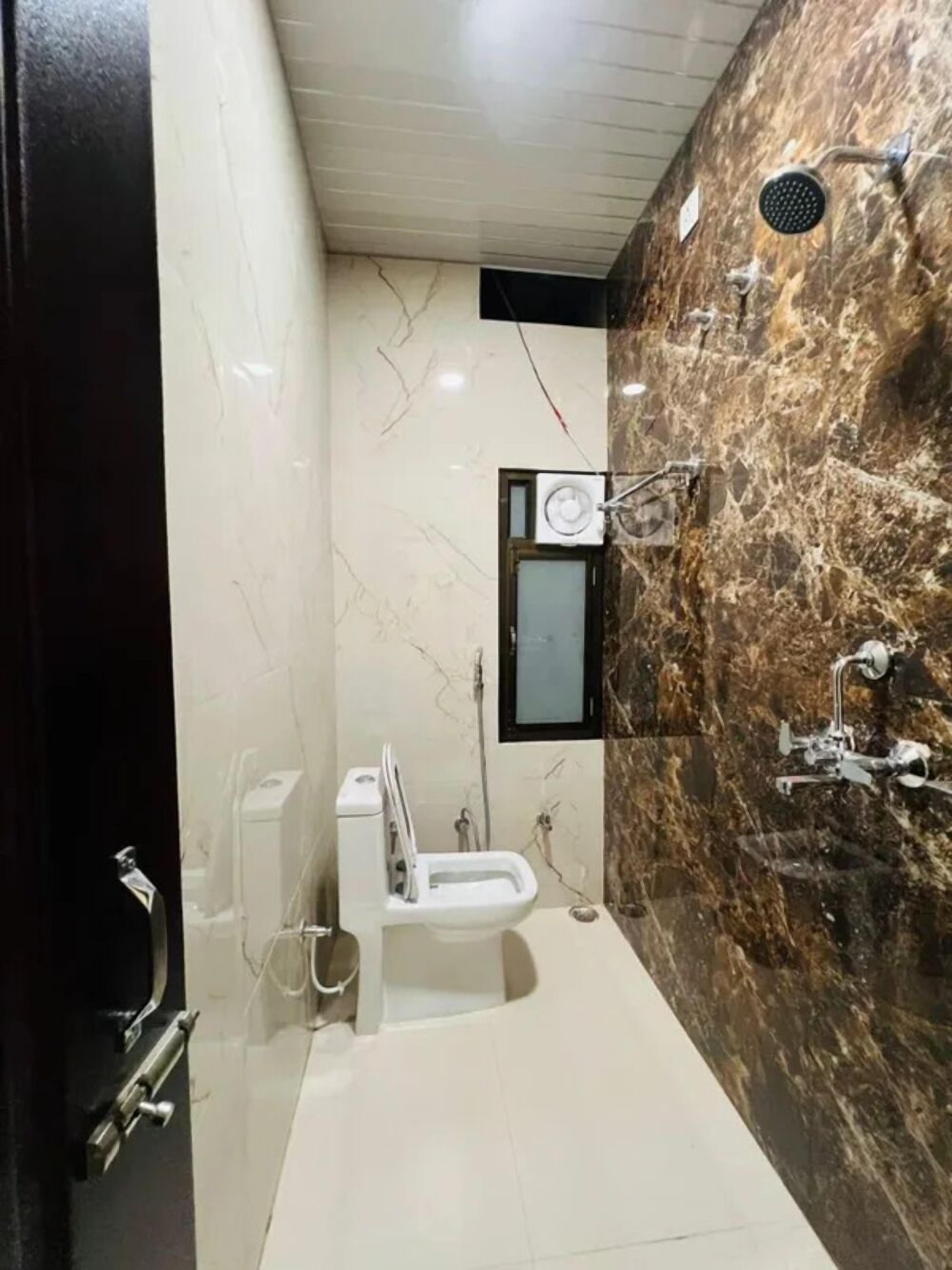 Shower, rainfall showerhead, towels, toilet paper