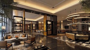 A spacious lobby with a central bar, seating areas, and a large open space with a patterned floor. - voco Beijing Temple of Heaven by IHG (Beijing)