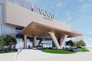 A modern building with a large overhang and the name 'Voco' prominently displayed. - voco Beijing Temple of Heaven by IHG (Beijing)