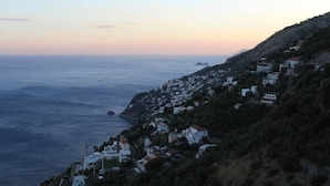 A coastal town with houses on a hillside, overlooking the sea. - From Grandfather Aurelius (Campania)