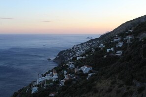 A coastal town with houses on a hillside, overlooking the sea. - From Grandfather Aurelius (Campania)