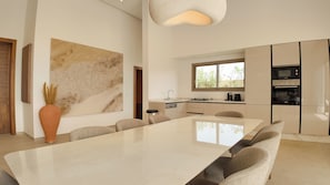 A modern kitchen with a large island, built-in appliances, and a large window. - Villa Clea heated pool not overlooked (MARRAKECH)
