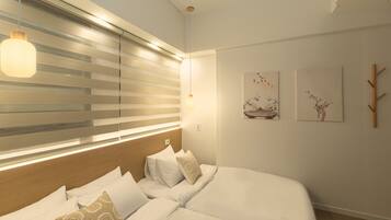 A modern bedroom with a large bed, bedside lamps, and artwork on the wall.