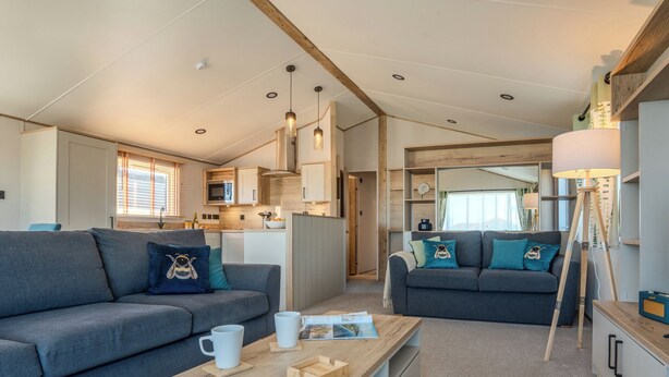 A modern interior with two sofas, a coffee table, and a lamp. - Exclusive 3 Bed (Pet) (Fowey)
