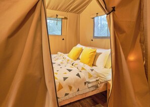 A tented room with a bed, two windows, and a curtain. - Safari Tent sleeps 6 Pet Friendly (Hayle)