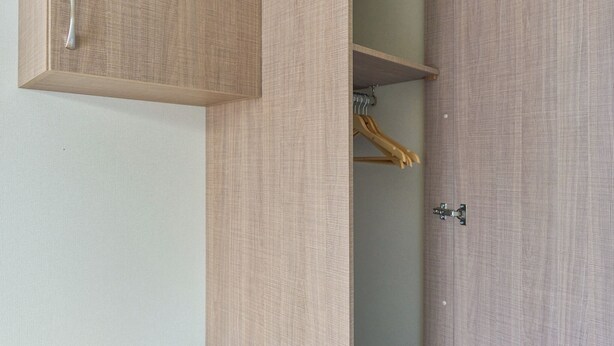 A bedroom with a bed, a wardrobe, and a door. - Standard 2 Bedroom sleeps 6 Pet Friendly (Hayle)
