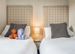 Two beds with headboards, pillows, a lamp, and a teddy bear on one bed. - Luxury 3 bedroom sleeps 8 Pet Friendly (Hayle)
