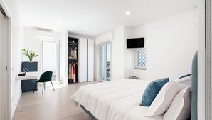A modern bedroom with a large bed, a desk, and a walk-in closet. - Sorrento Sea View Villa - 4BR, Panoramic Terraces & Private Parking (Priora)