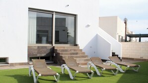 A modern outdoor area with a pool, sun loungers, and a staircase leading to a covered deck. - 5 Bed 4 Bath Villa, Private Pool, Modern, All Amenities, Pau26 Villamartin (Orihuela)