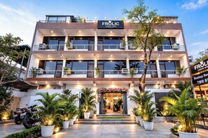 A multi-story building with a sign reading "FROLIC LUXURY STAY". - Frolic Hotel Near Sec 52 Noida Metro Station (Noida)