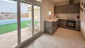 A modern kitchen with a built-in oven, a microwave, and a sink. - Lovely home in Petra with private swimming pool, can be inside or outside (Petra)