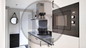 A modern kitchen with a built-in microwave, a coffee maker, and a kettle. - Stunning home in Vinkeveen with sauna (Vinkeveen)