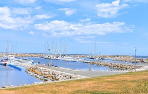 A marina with boats docked, a rocky shoreline, and a clear sky. - 3 bedroom nice home in Simrishamn (Simrishamn)