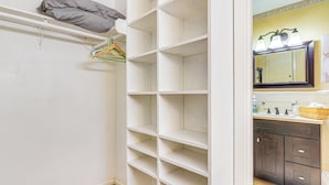 A bathroom with a white vanity, a mirror, and a shower area. - Shop, Dine & Explore: Home 3 Mi to NRG Stadium (Houston)
