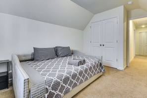 A bedroom with a bed, two pillows, a rolled towel, a nightstand, and a closet. - 4 Mi to Hospital & Dtwn Greensboro: Spacious Home (Greensboro)