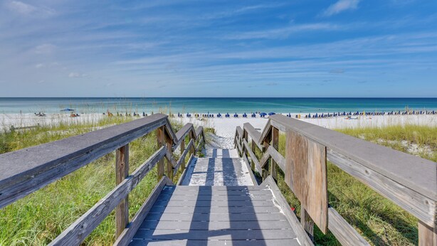 A wooden boardwalk leading to a beach with clear skies. - Steps to Sea! Snowbird Haven in Miramar Beach (Miramar Beach)