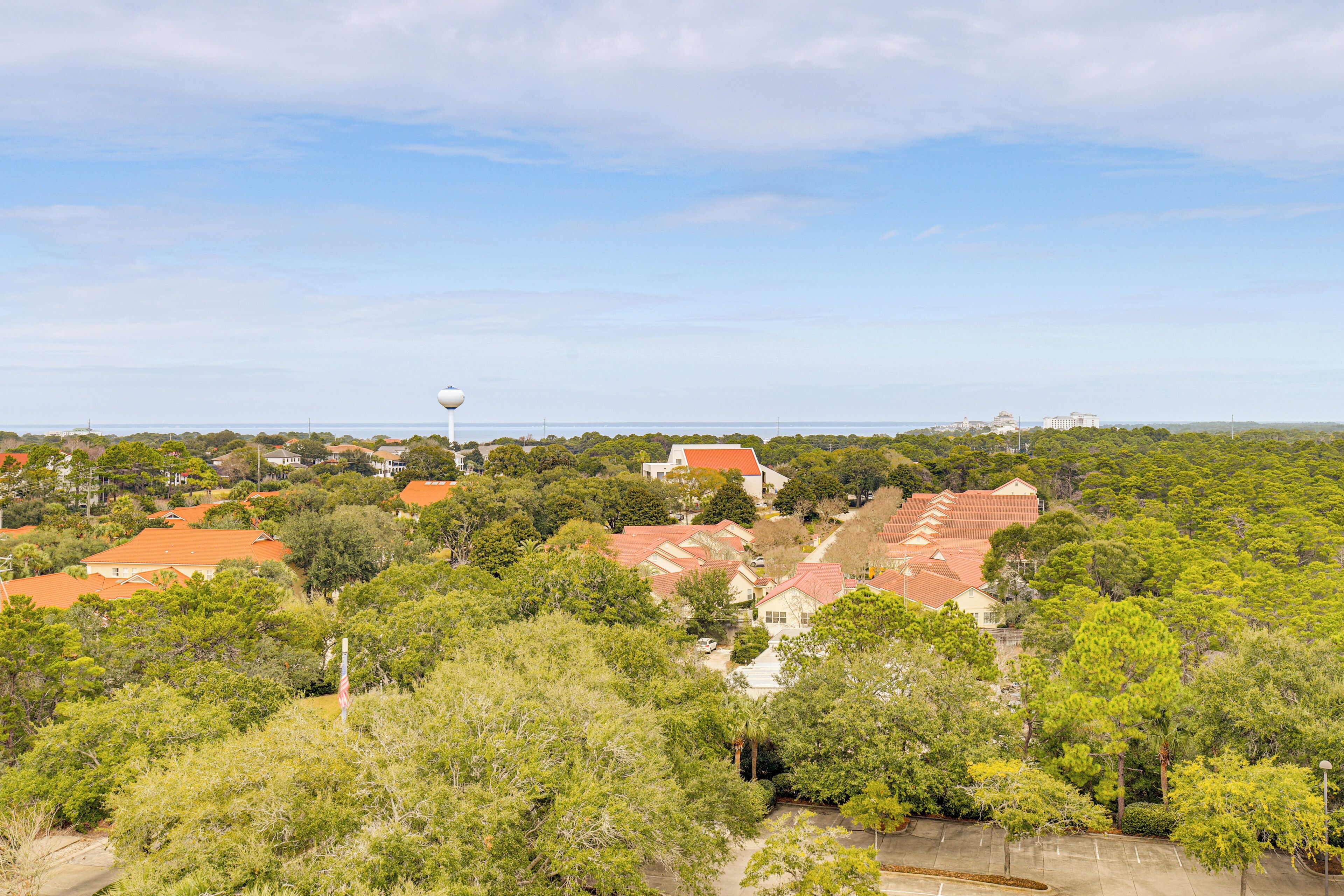 A residential area with houses, trees, and a water tower.