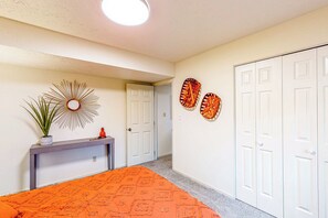 A bedroom with a bed, a console table with a plant, and a door leading to another room. - 3 Mi to IU! Family-friendly Bloomington Home (Bloomington)