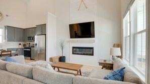 A spacious living room with a large sofa, a coffee table, and a fireplace. - Steps to Marina! Lake Greenwood Home w/ Patios (Greenwood)