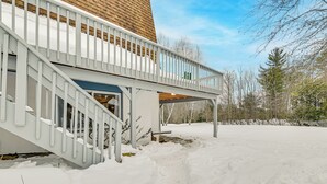 A snow-covered deck with a wooden staircase leading to a building. - 3 Mi to Windham Mountain: Pet-friendly Apt w/ Yard (Hensonville)