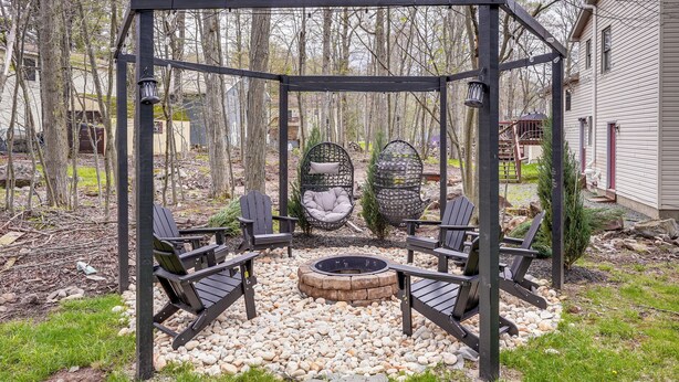 A gazebo with a fire pit, two rocking chairs, and a seating area with Adirondack chairs. - Family Getaway w/ Deck Near Tobyhanna State Park (Tobyhanna)