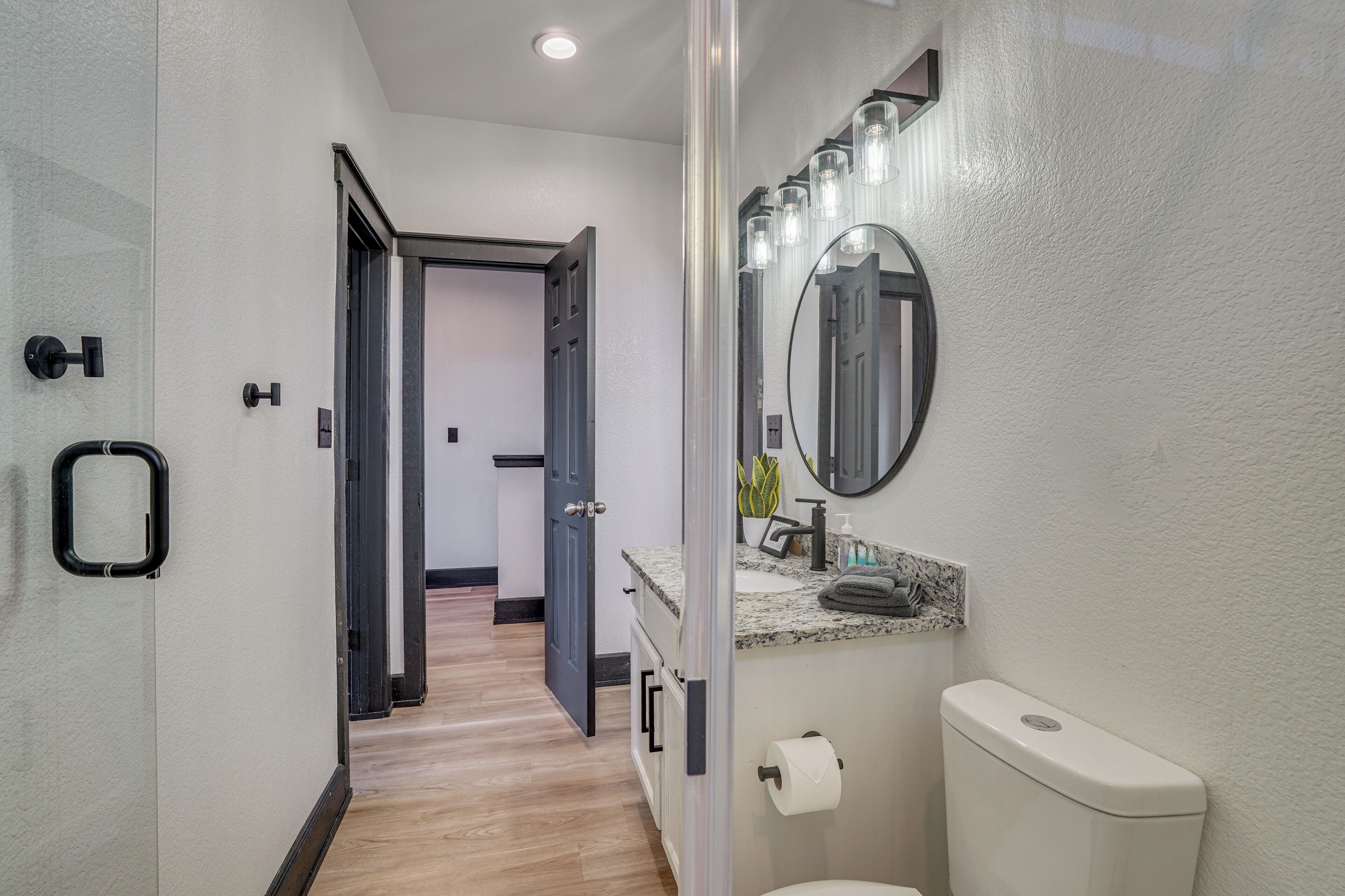 Une salle de bain moderne équipée de toilettes, d’un lavabo et d’un miroir.