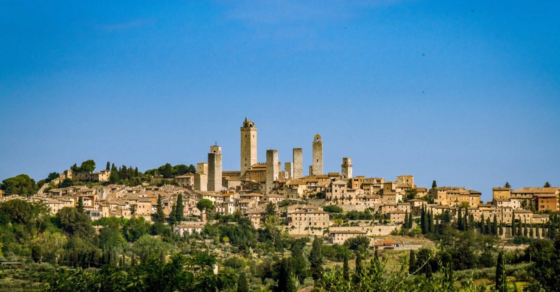 A historic town with medieval architecture, including towers and fortified walls.