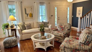 A living room with a sofa, armchairs, a coffee table, and a lamp. - In-town Lewes house with great floor plan!  112 Bradley Lane (Lewes)