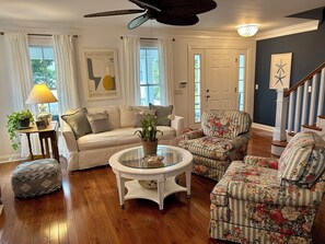 A living room with a sofa, armchairs, a coffee table, and a lamp. - In-town Lewes house with great floor plan!  112 Bradley Lane (Lewes)