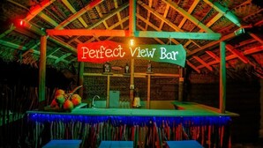 A rustic bar named "Perfect View Bar" with a thatched roof and colorful lighting. - Perfect view mirissa (Mirissa)