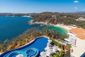 A resort with a large swimming pool, beach, and mountainous backdrop. - 2B Beach View | Shared Pool & Beach Access (Huatulco)