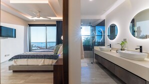 Ein modernes Schlafzimmer mit einem Bett, einem Deckenventilator und einem großen Fenster.