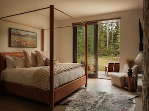 A four-poster bed with a view of a forest through a sliding glass door. - 8 Speedwell 4 Bedroom Home (Big Sky)