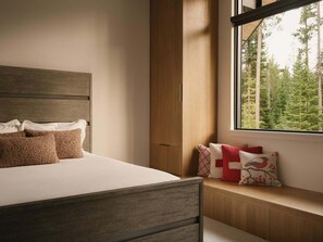 A bedroom with a bed, a window with a view of trees, and a wooden headboard. - 8 Speedwell 4 Bedroom Home (Big Sky)