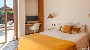 A bedroom with a bed, a desk, a chair, and a television. - Villa Zen'O | Palmeraie view | Heated swimming pool (Marrakech)