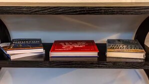 A shelf with three books titled "Houston," "The Red Line," and "Shuttle Houston." - Entire Property_Charming House_Museum District (Houston)