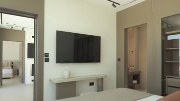 A modern hotel room with a bed, a mounted TV, a small console table, and a wardrobe.