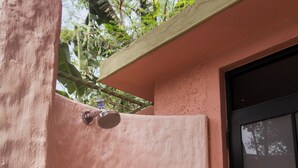 A pink wall with a metal door and a window. - Flor De Lis - 4 BHK Villa w/Pool, wifi & parking behind Sakana in Anjuna (Vagator)