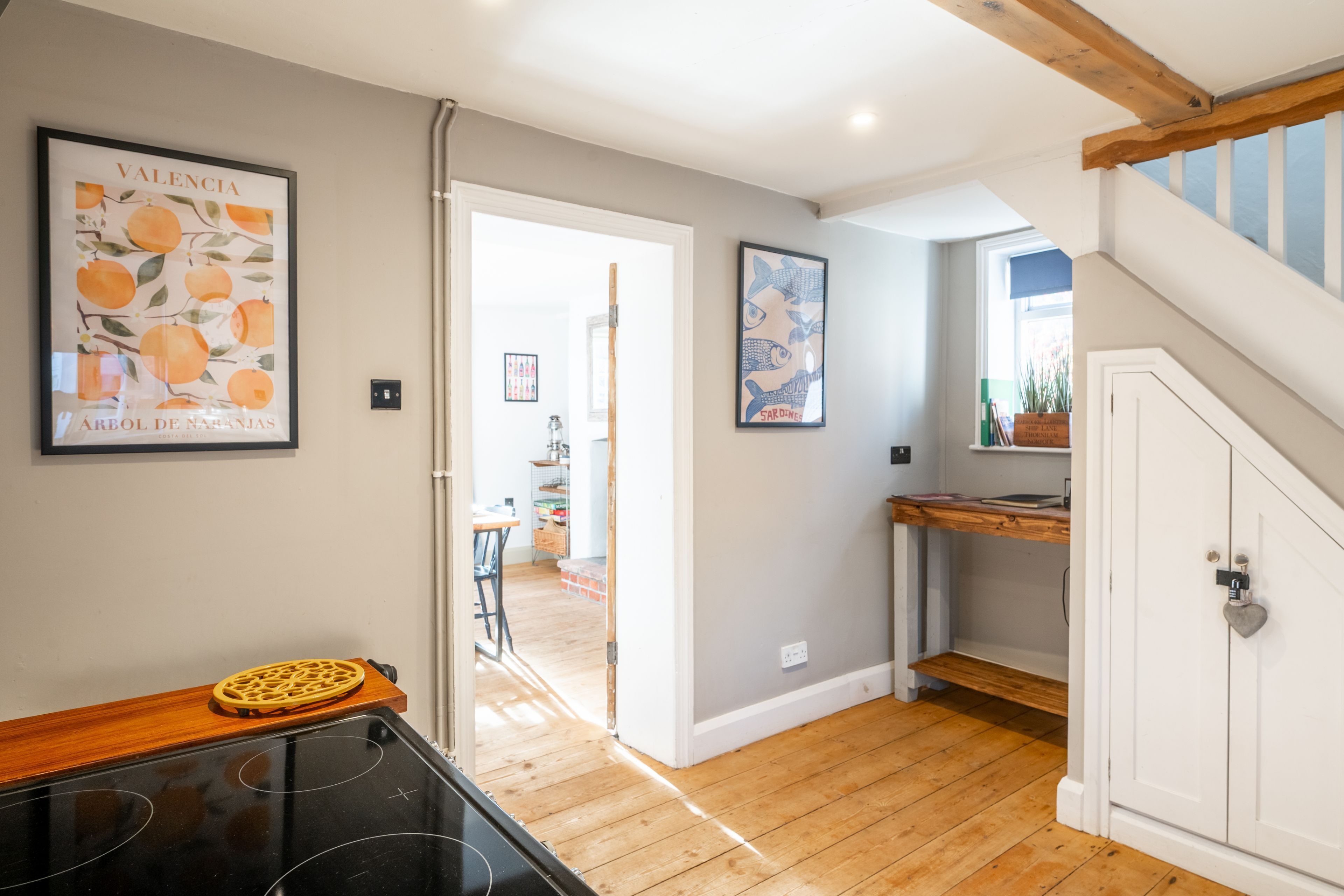 A kitchen with a wooden countertop, a stove, and a door leading to another room.