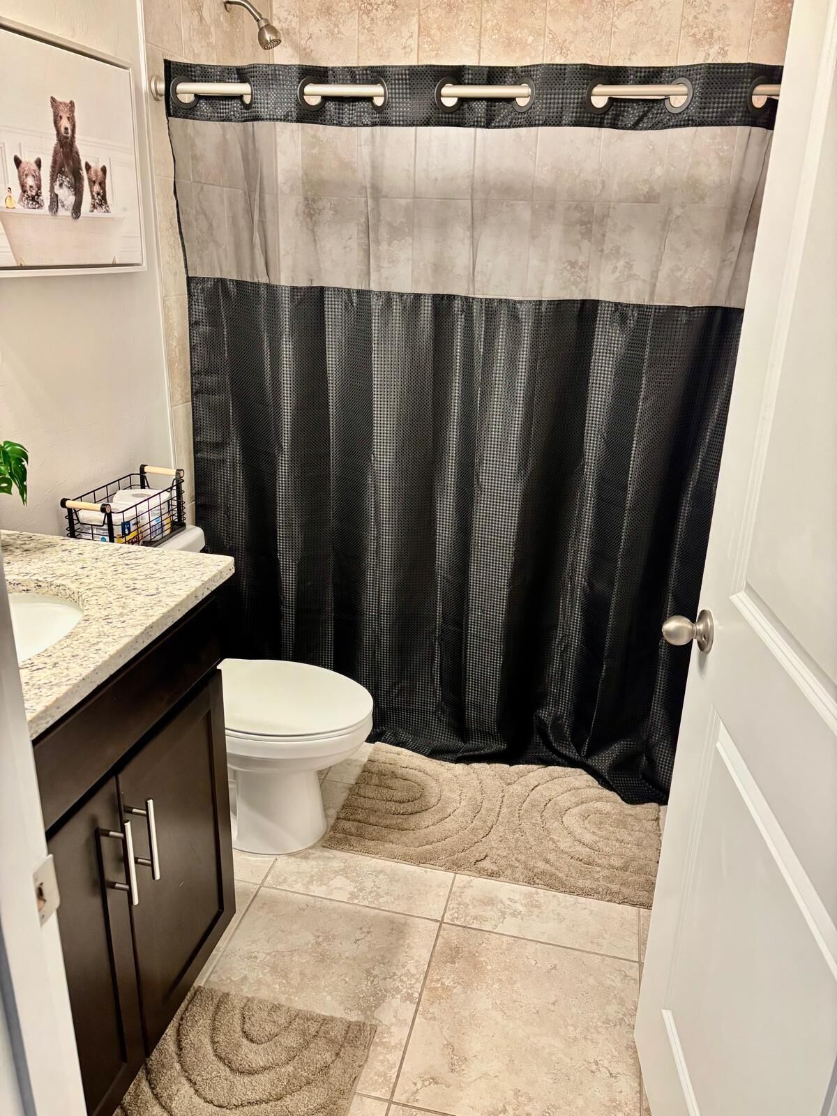 A bathroom with a toilet, a sink, and a shower curtain.