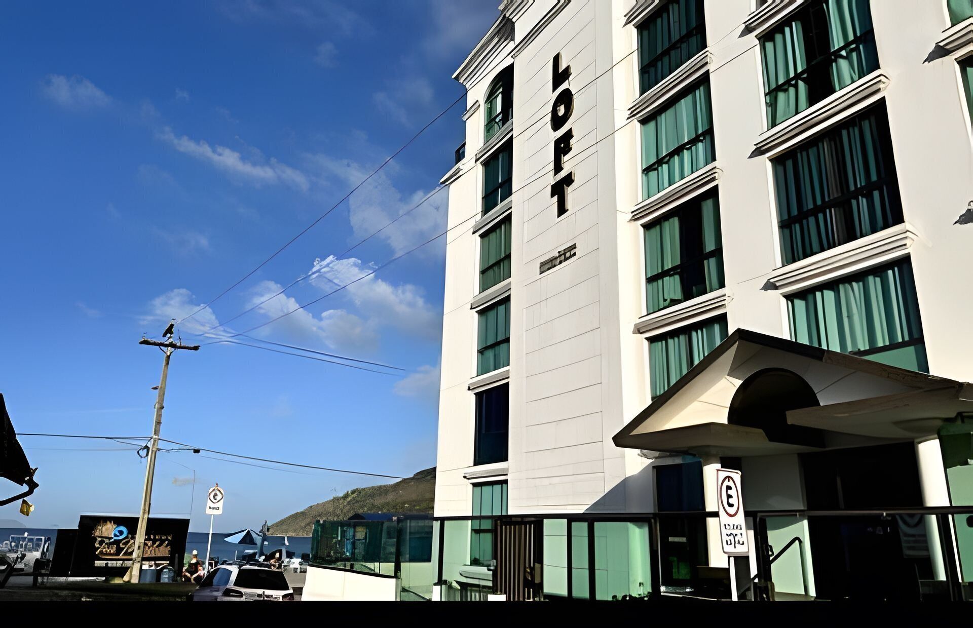 A multi-story hotel with a prominent 'LOFT' sign, large windows, and a modern architectural style.